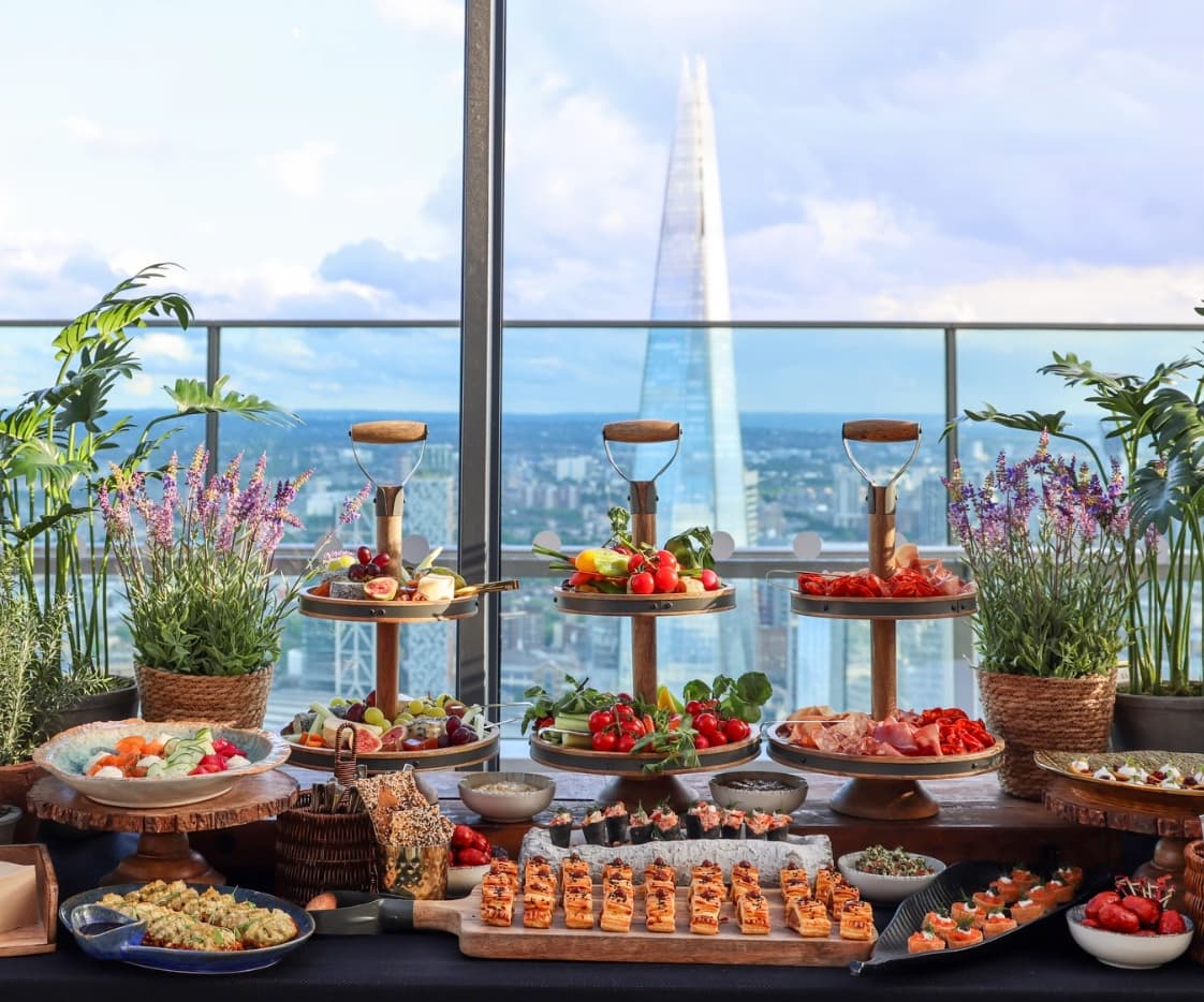 Canapés laid out at Sky Garden, the Shard through the glass behind.